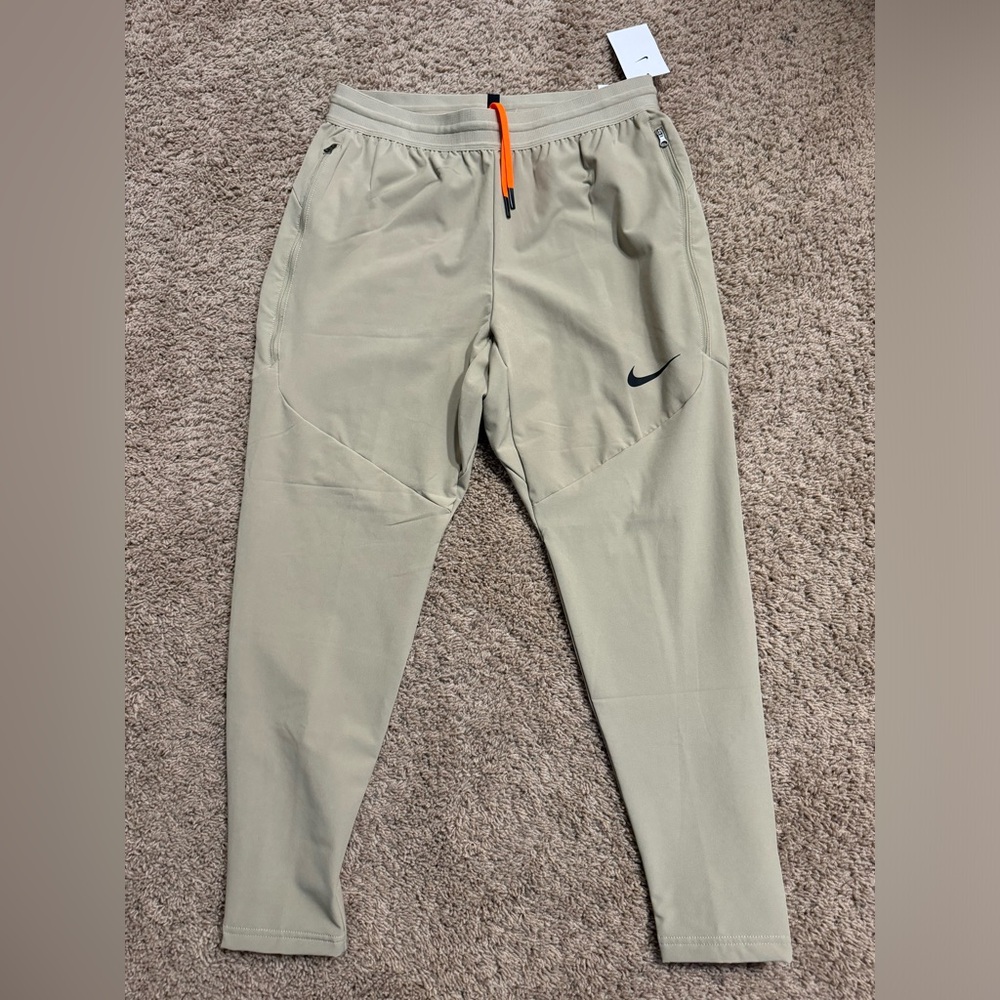 Nike Men's Beige Sweatpants with Black Swoosh and Orange Drawstring